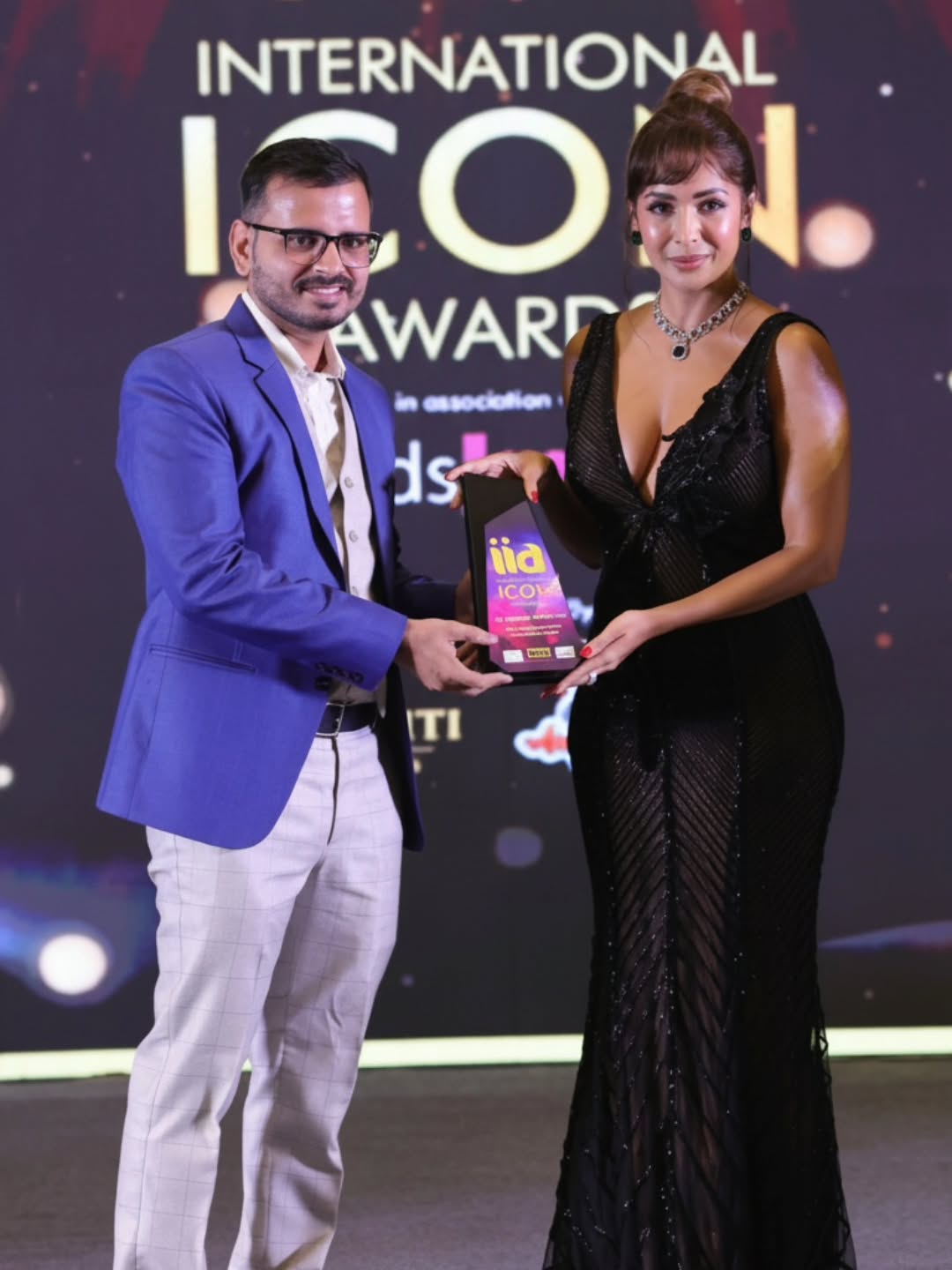 Dr. Deepak Dhankhar Receiving Award from Malaika Arora
